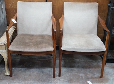 A pair of mid century teak upholstered elbow chairs, width 54cm, depth 63cm, height 84cm